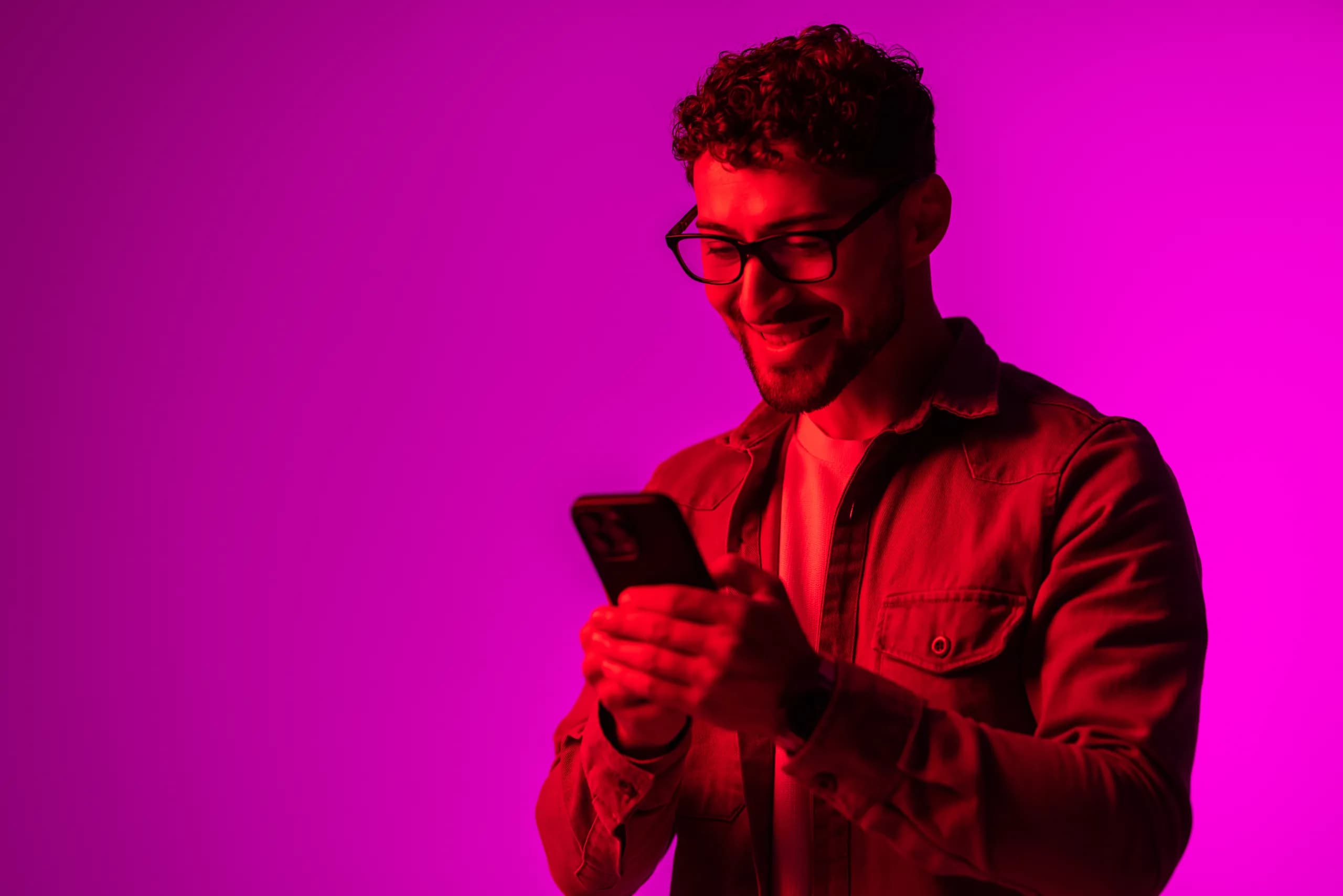 A happy client against a neon backdrop